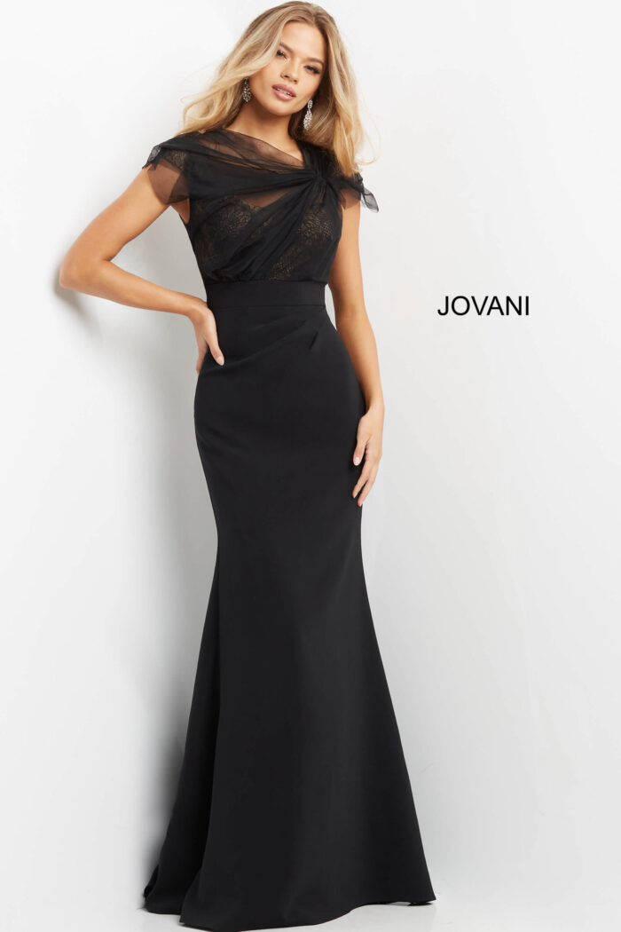 Model wearing Jovani 05675 black gown with lace bodice and mermaid silhouette.