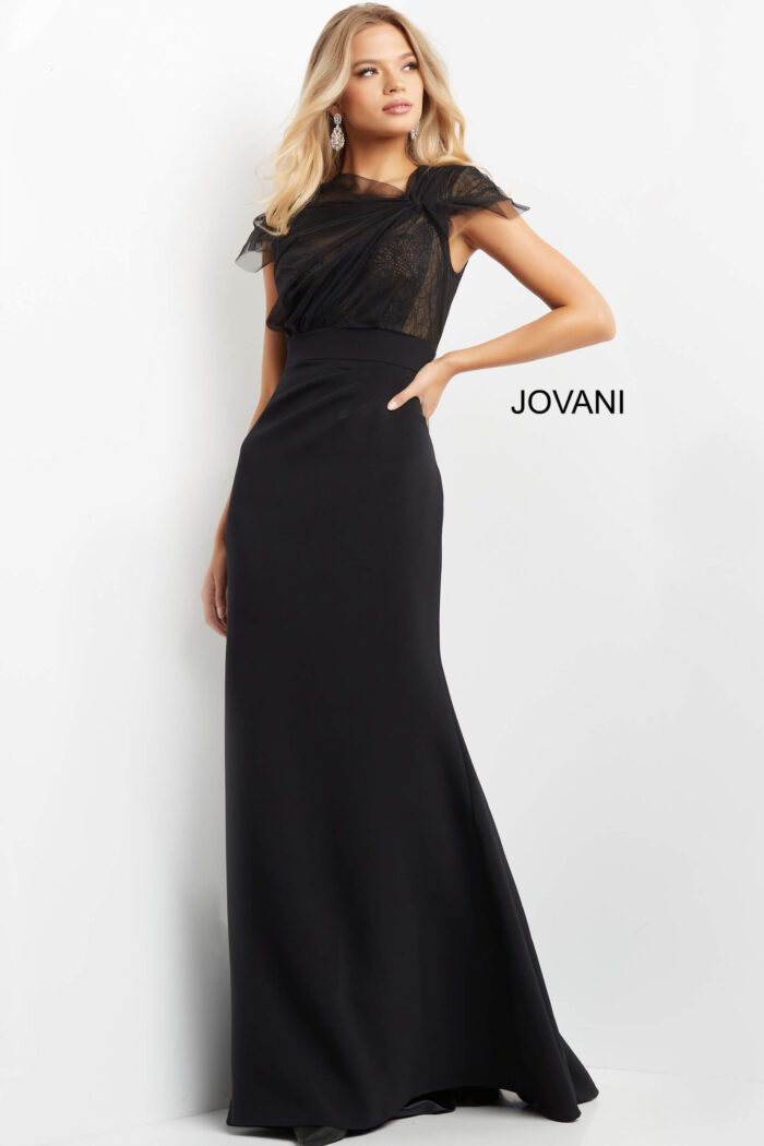 Model in Jovani 05675 black gown featuring lace details and sheath skirt.