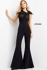 Model wearing Jovani 05676 black jumpsuit with lace detailing and wide-leg pants.