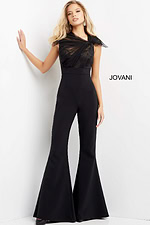 Model wearing Jovani 05676 black jumpsuit with lace bodice and flared legs.