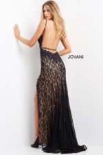Model wearing Jovani 05850 black evening gown showcasing lace and high slit details.