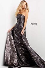 Model wearing Jovani 06255 gray gown showcasing intricate detailing with a relaxed pose.