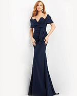Model wearing Jovani 06403 navy blue gown with off-the-shoulder neckline.