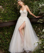 Model in Jovani 06610 white gown, showcasing elegant floral details and train.