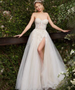 Side view of Jovani 06610 white gown with high slit and floral accents.