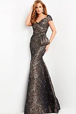 Model wearing Jovani 06707 bronze mermaid gown with sweetheart neckline and short sleeves.