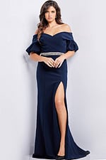 Model wearing Jovani 06830 navy dress with off-the-shoulder neckline and embellished waist, front view.