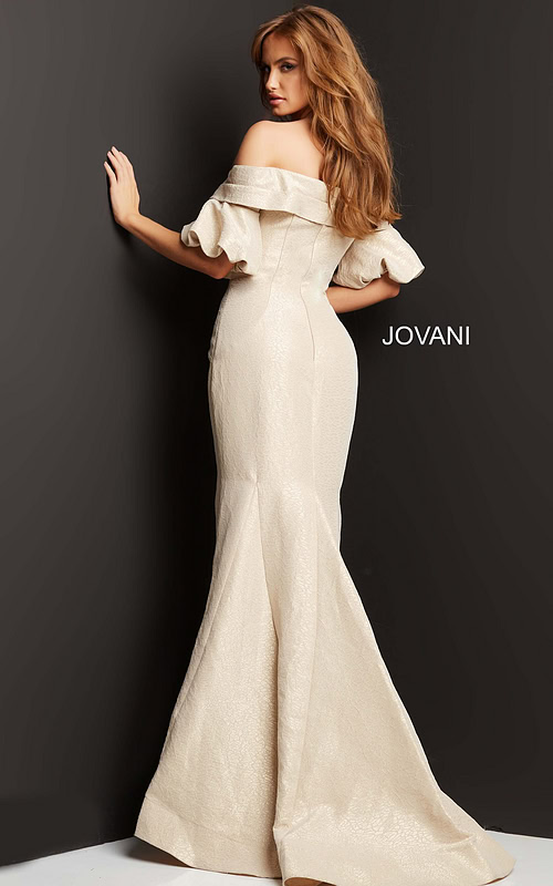 Model in Jovani 06831 beige dress, back view, highlighting elegant mermaid silhouette.