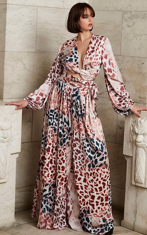 Model wearing Jovani 06845 dress with a deep V-neckline and long sleeves in multi-color.