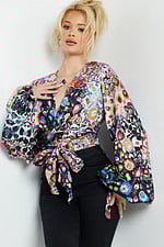 Model displaying Jovani 06847 wrap top with vibrant print and fitted waist