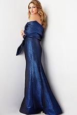 Model wearing Jovani 06867 in blue, back view.