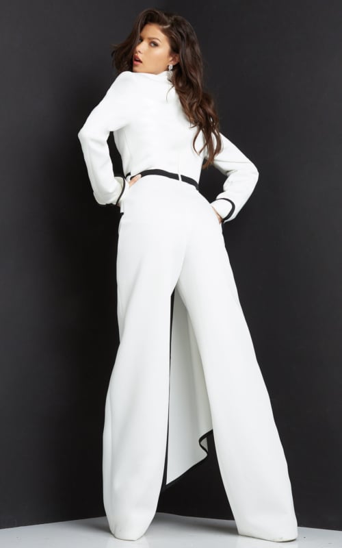 Model wearing Jovani 06917 white jumpsuit with black trim, back view.