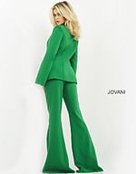 Model wearing Jovani 06922 emerald green jumpsuit with cape sleeves, back view.