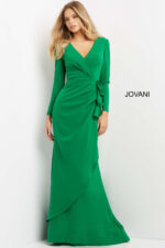 Model wearing Jovani 06995 emerald green dress with V-neckline and long sleeves.