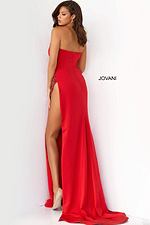 Model wearing Jovani 07138 red dress with sweetheart neckline and high slit from the back view.