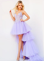 Model in Jovani 07263 lilac high-low tulle dress with a plunging lace neckline.