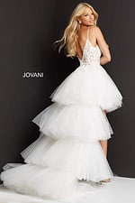 Model wearing Jovani 07263 back view of tulle high-low dress in white with lace accents.