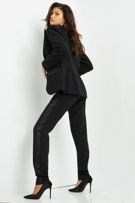 Model wearing Jovani 07293 black jumpsuit, back view.