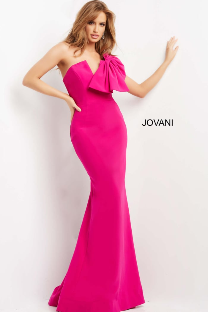 Front view of model wearing Jovani 07306, elegant fuchsia dress with bow detail.