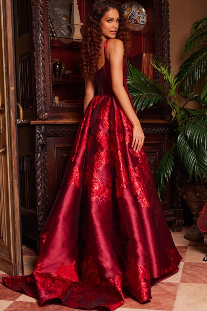 Model in Jovani 07441 purple gown from the back, highlighting the elegant silhouette and embroidery.