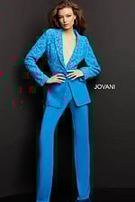 Model wearing Jovani 07551 blue lace blazer with trousers, front view