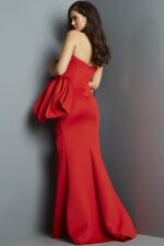 Model wearing Jovani 07581 red gown showing back view with dramatic side drape.