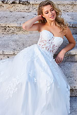 Model wearing Jovani 07901 white gown with floral detail