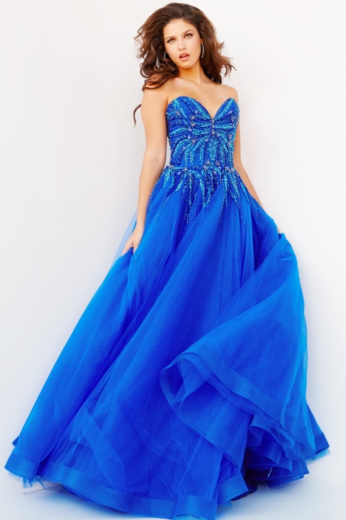 Model showcasing Jovani 07946 royal blue ball gown with a beaded bodice and flowing skirt.