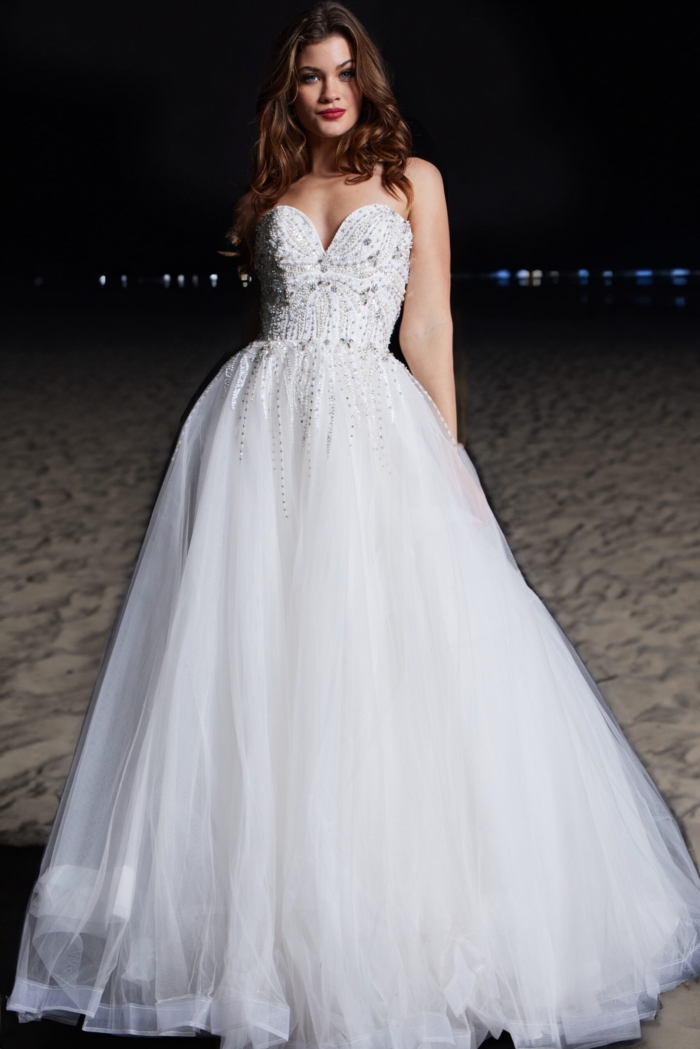 Model in Jovani 07946 white ball gown, featuring a sweetheart neckline and beaded bodice.