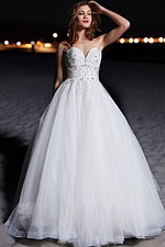Model wearing Jovani 07946 white ball gown with intricate beading and full tulle skirt.