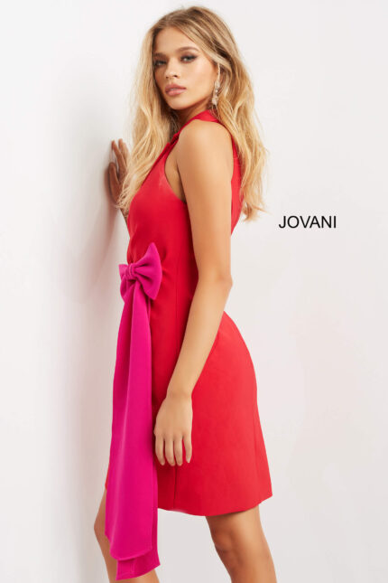 model wearing Jovani 07961 red dress with fuchsia bow detail, angled view