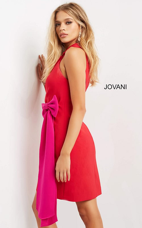 model wearing Jovani 07961 red dress with fuchsia bow detail, angled view