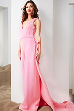 Model wearing Jovani 08000 pink jumpsuit, posed elegantly with fabric flowing from the waist.