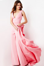 Model wearing Jovani 08000 pink jumpsuit with draping fabric detail on the side.