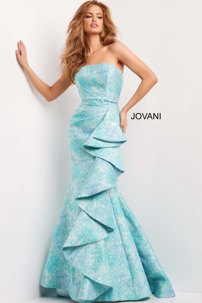 Model in Jovani 08093 gown with strapless neckline and dramatic ruffles in blue multi.