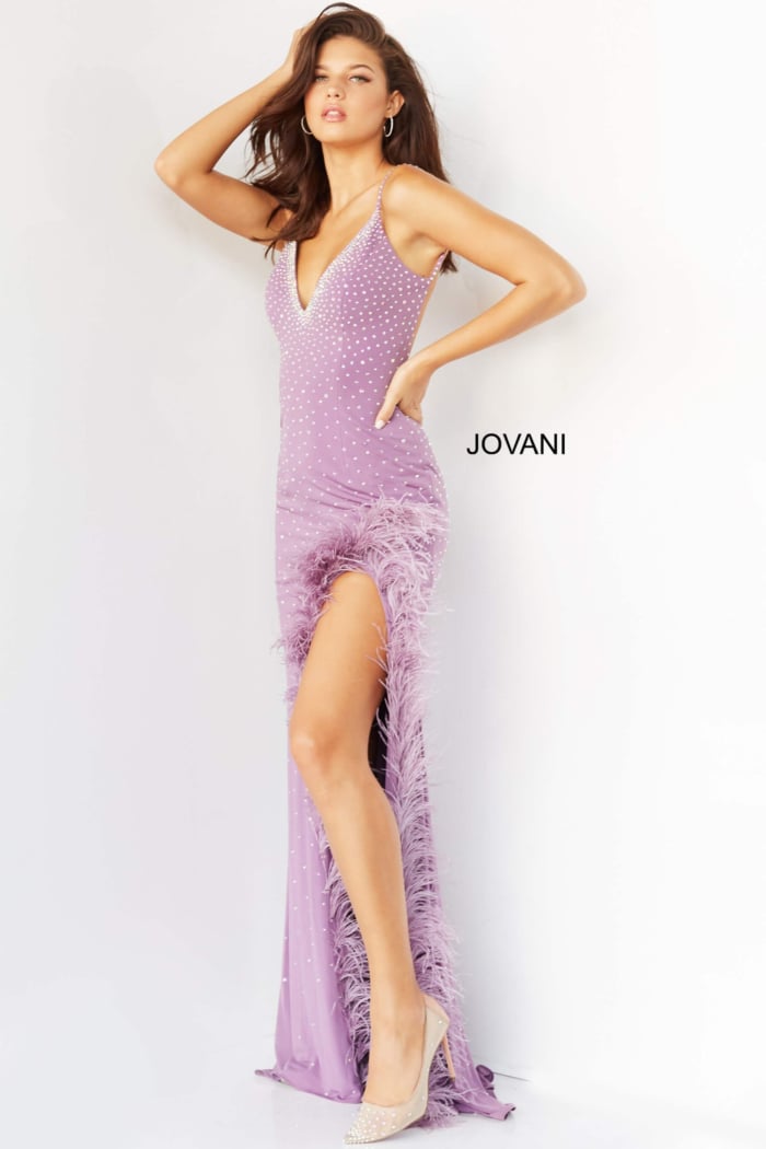 Model wearing Jovani 08283 lilac gown with V-neckline and striking feather details.