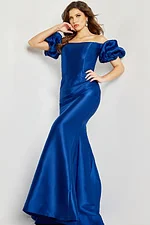 Model posing in Jovani 08361 indigo mermaid gown with off-shoulder puff sleeves.