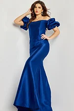 Front angle of model in Jovani 08361 indigo mermaid gown with off-shoulder puff sleeves.