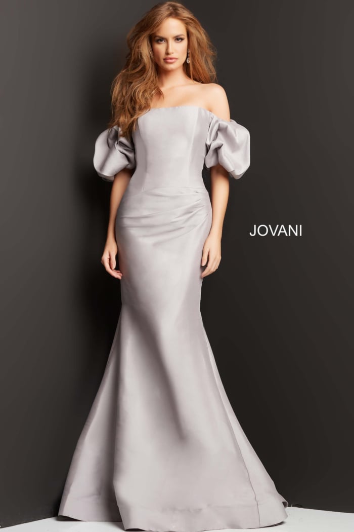 Model showcasing Jovani 08361 gown with off-shoulder design, puff sleeves, and fitted bodice.