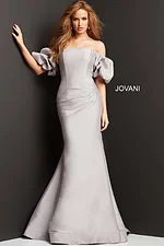 Front view of model in Jovani 08361 taupe mermaid gown with off-shoulder puff sleeves.