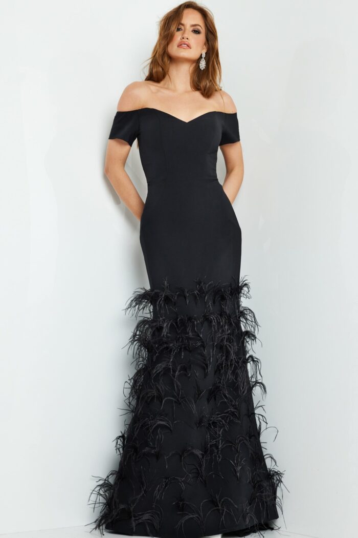 Model posing in Jovani 08384 black off-the-shoulder gown with feathered skirt.