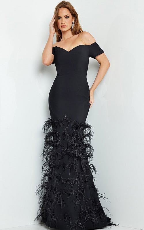 Model wearing Jovani 08384 black off-the-shoulder mermaid gown with feather details.
