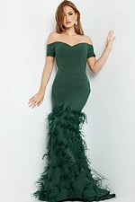 Model wearing Jovani 08384 green off-the-shoulder mermaid dress, leaning against wall