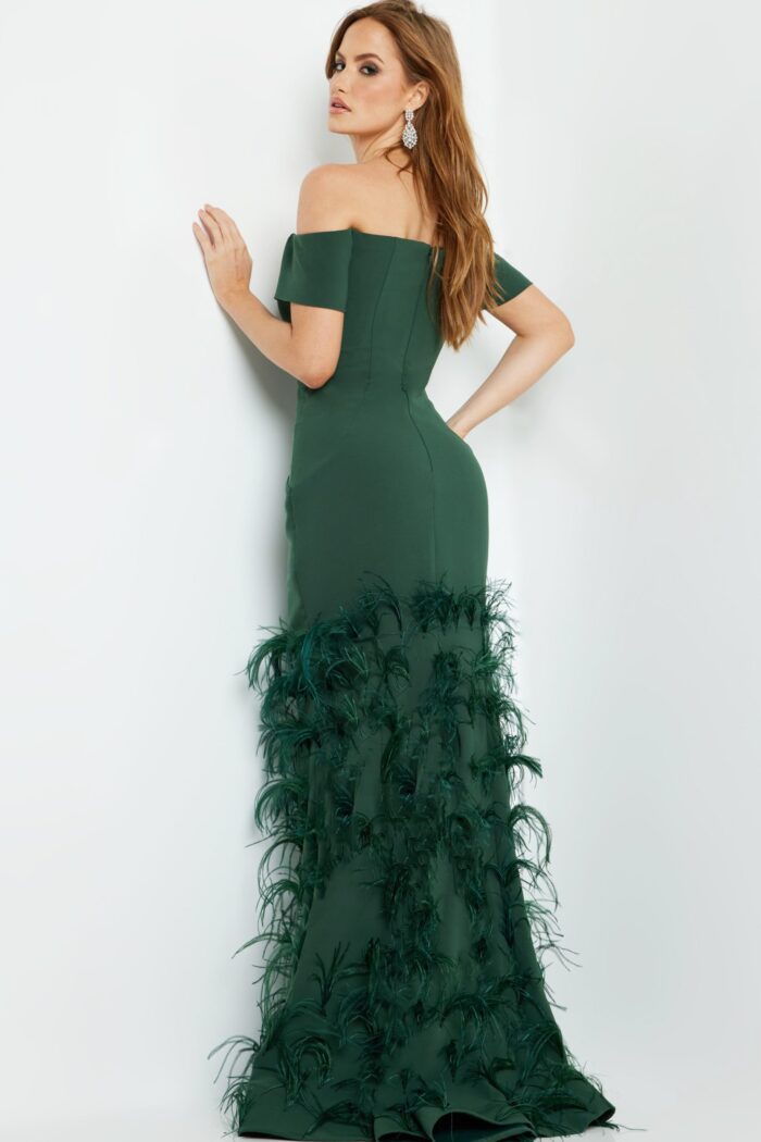 Model displaying the back of Jovani 08384 green mermaid gown highlighting feather details.