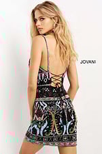 Model wearing Jovani 08447 black multi dress showing back lace-up detail.