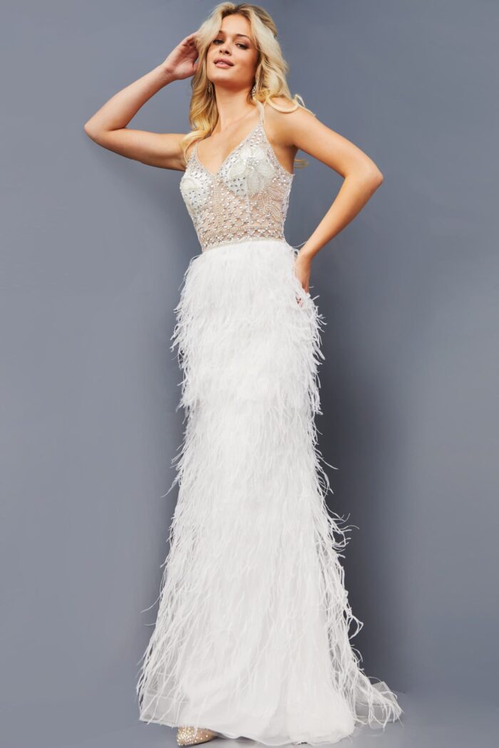 Model wearing Jovani 08525 front view of white gown with feathered skirt and sheer bodice.