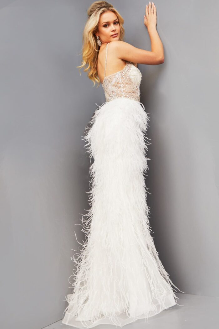 Model wearing Jovani 08525 back view highlighting the sheer back and continuation of the feathered skirt.