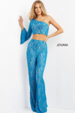 Model wearing Jovani 08693 blue lace ensemble with asymmetrical neckline.