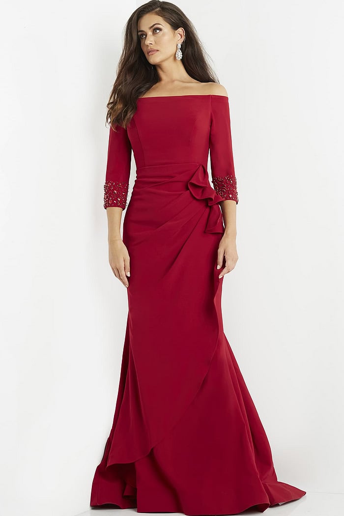 Jovani 08699 red off-the-shoulder gown with ruched waist detail worn by model.