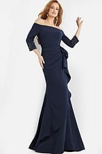 Jovani 08699 navy gown with cascading bow detail worn by model.